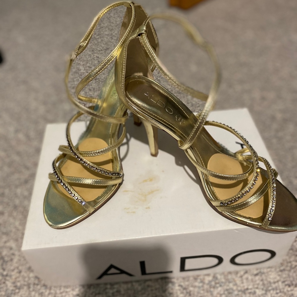 Gold heels with rhinestone embellishments.